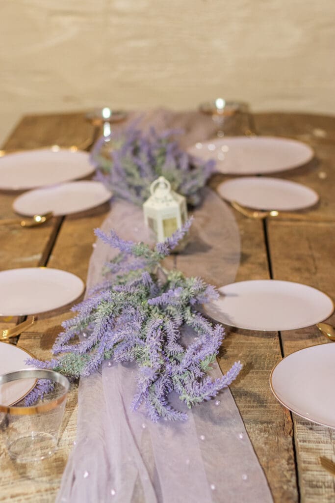 Table scape with lavendar, tulle runner, and votive candles